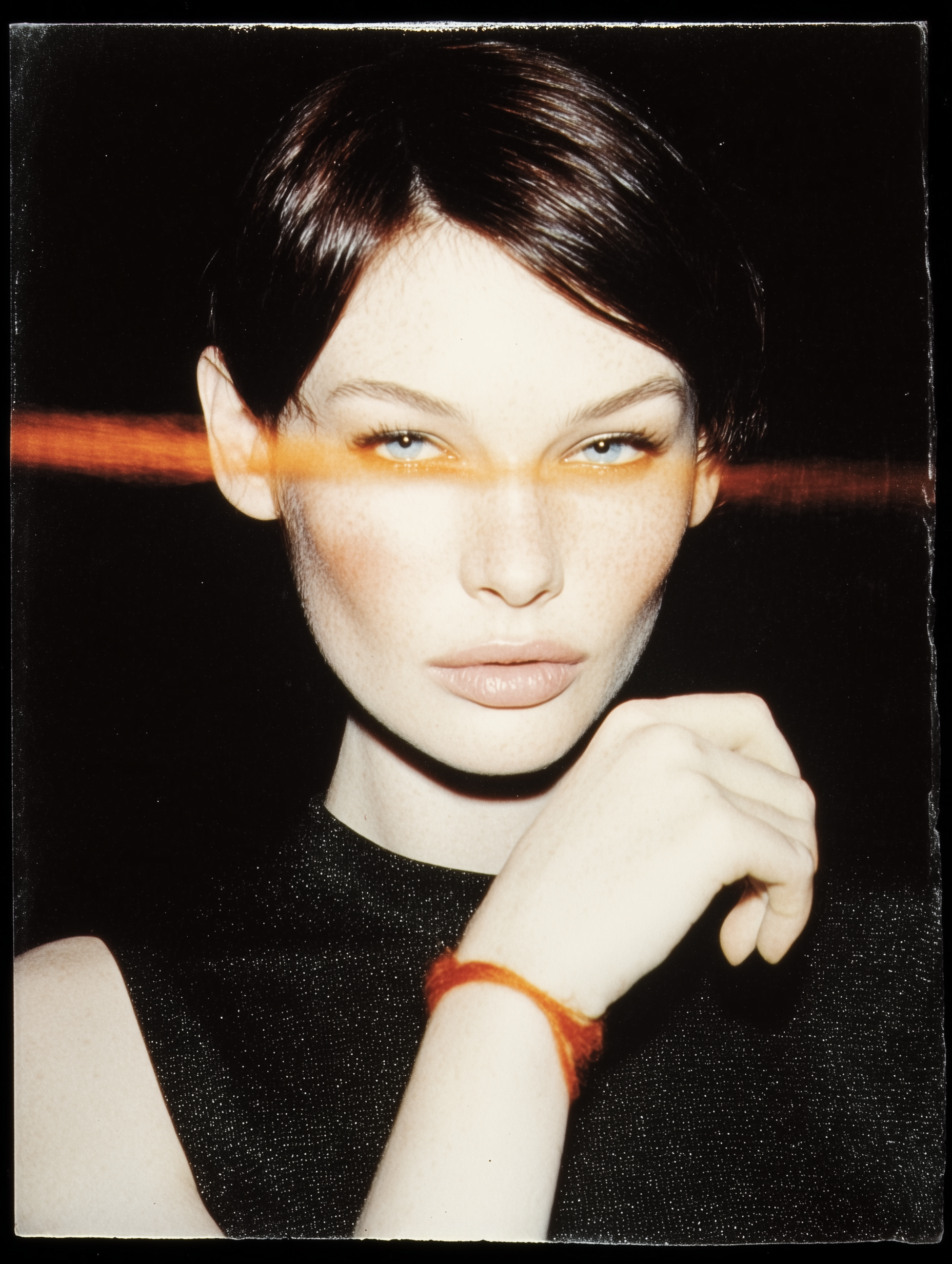 Woman with a red line on her face against a black background